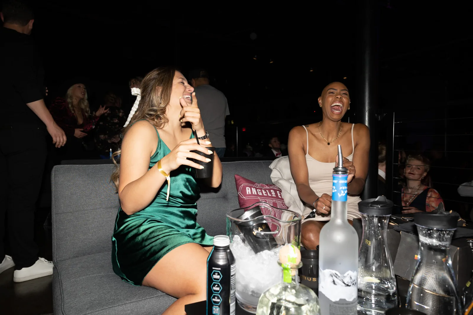 Friends laughing over drinks at a FAMUS event